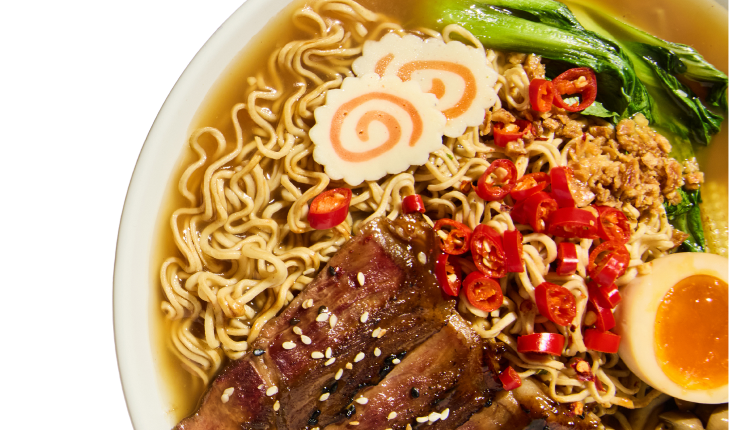  bowl of noodles with various toppings including meat, vegetables, and a soft-boiled egg.