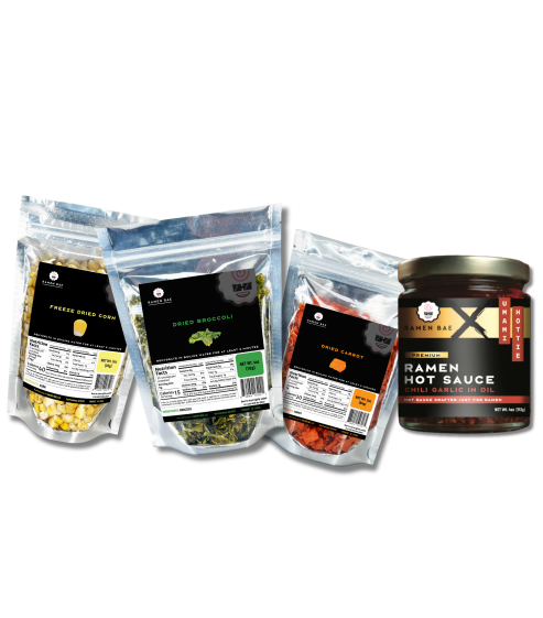 Four packages of different types of ramen ingredients and a can of ramen hot sauce on a white background