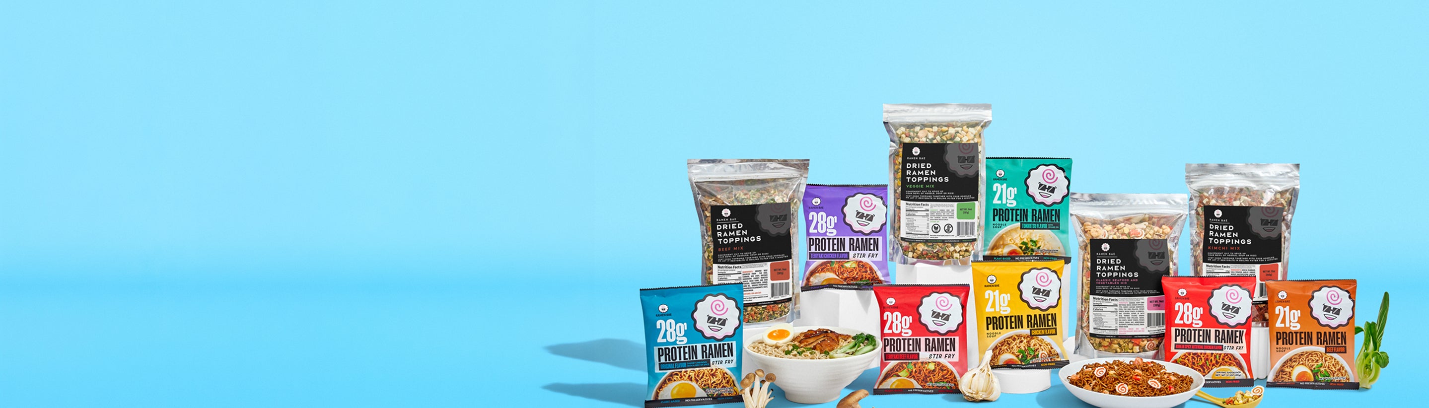 Assorted protein bar packages and bowls on a blue background
